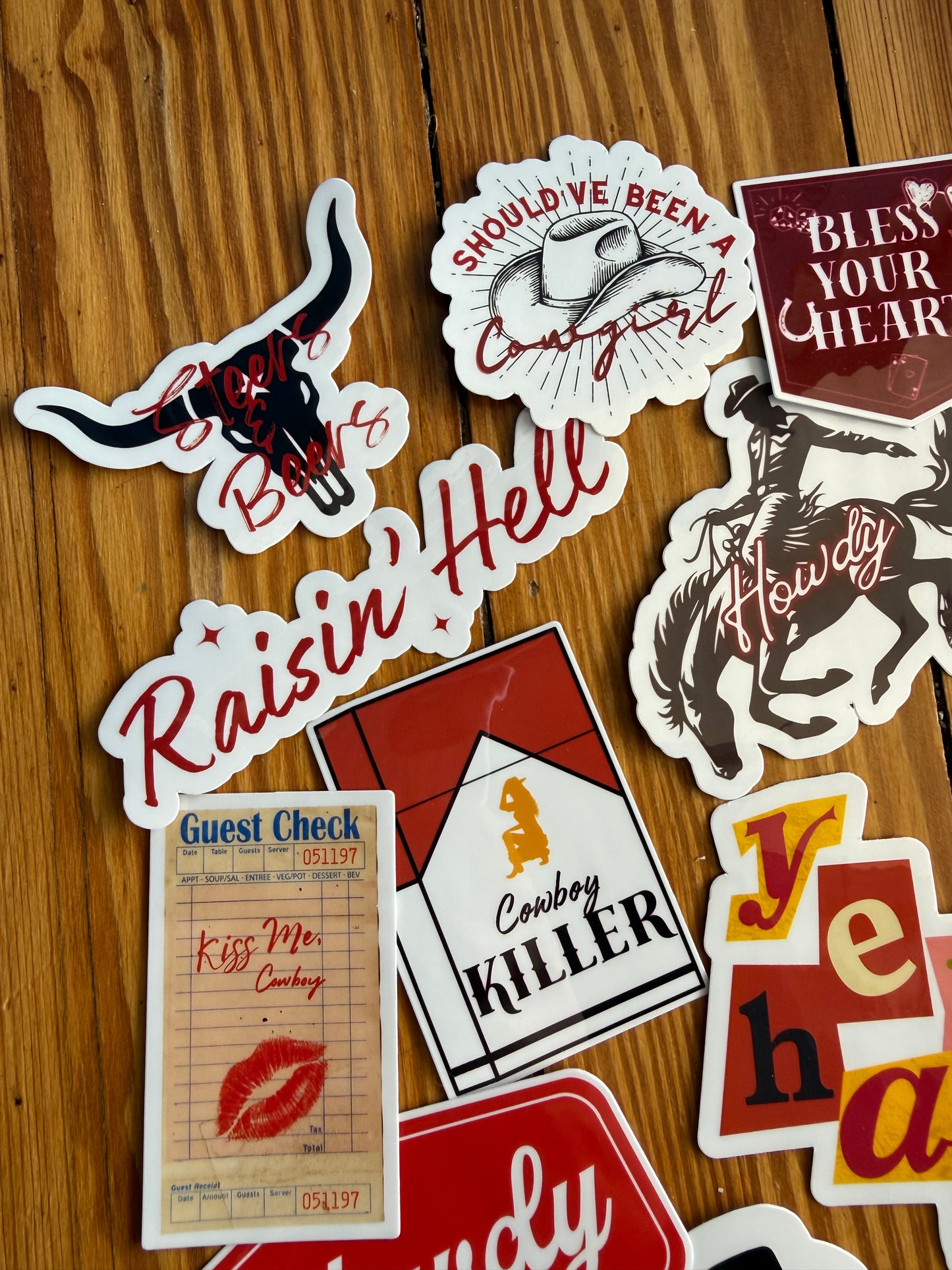 Western sticker pack detail with "Should’ve Been a Cowgirl," "Steers and Beers," and "Cowboy Killer" cigarette pack design; glossy vinyl decals for edgy western decor.