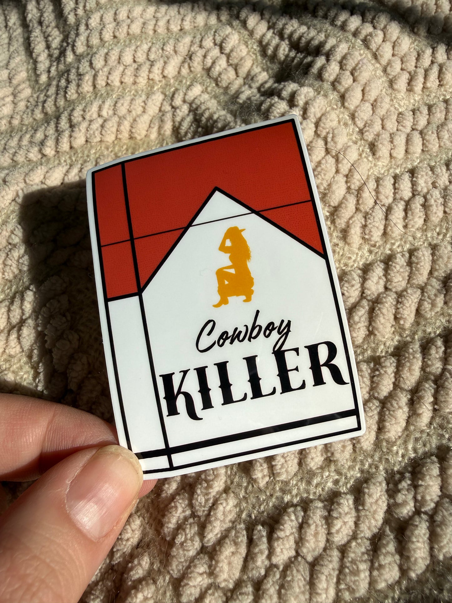 "Cowboy Killer" cigarette pack sticker with a golden cowgirl silhouette; edgy chic western accessory for smokers or retro aesthetic lovers.
