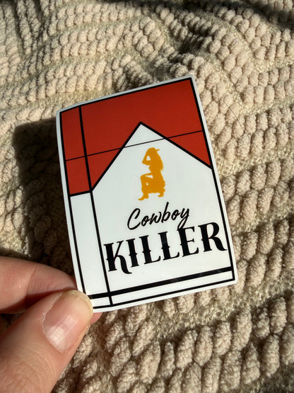 "Cowboy Killer" cigarette pack sticker with a golden cowgirl silhouette; edgy chic western accessory for smokers or retro aesthetic lovers.