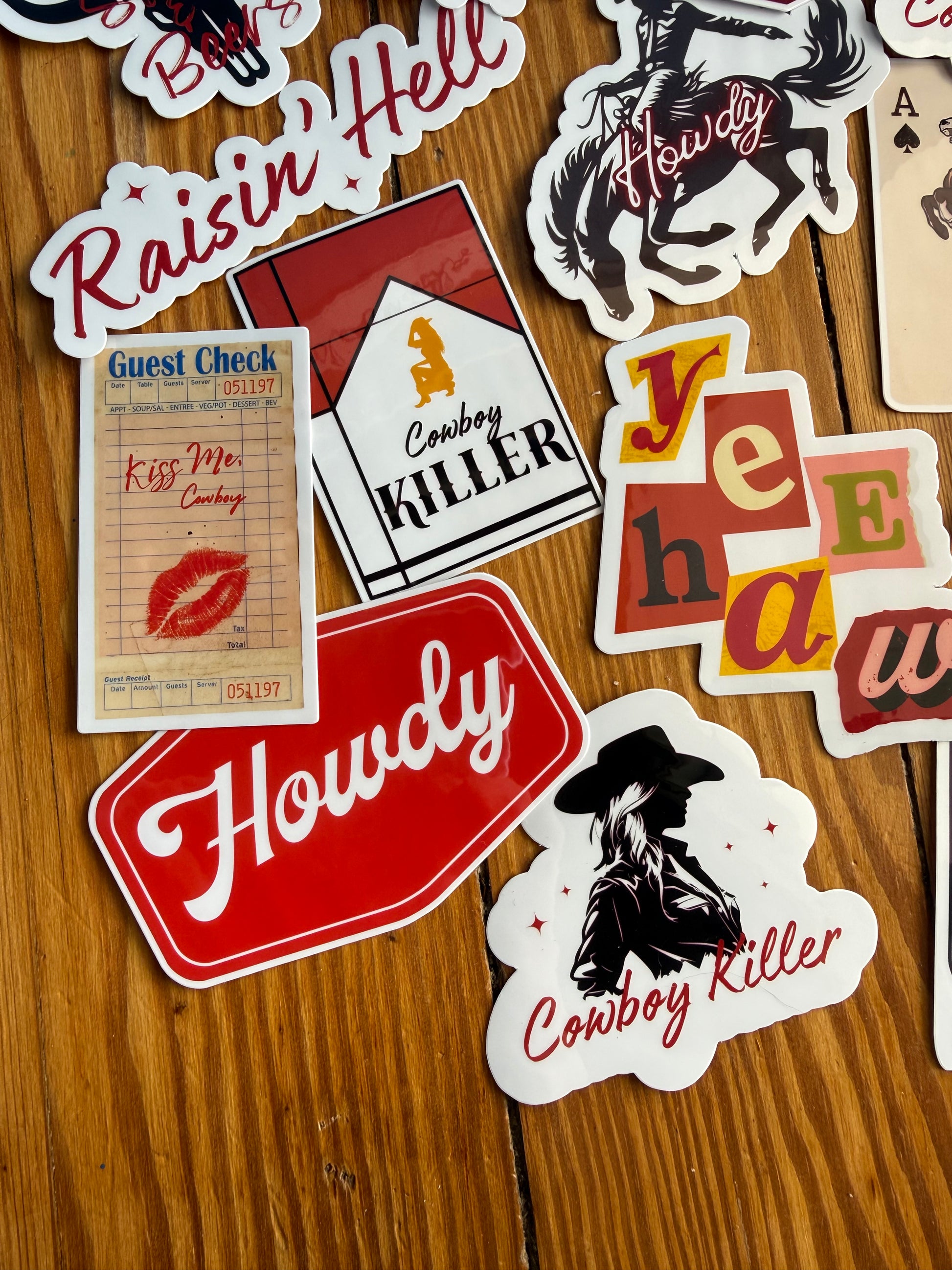 "Kiss Me Cowboy" and red "Howdy" stickers for cowgirl bachelorette party favors or western gift ideas; durable, water-resistant vinyl material.