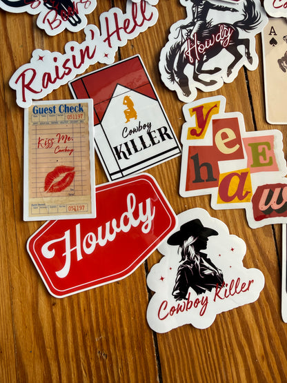 "Kiss Me Cowboy" and red "Howdy" stickers for cowgirl bachelorette party favors or western gift ideas; durable, water-resistant vinyl material.